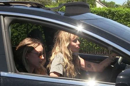 Miley Cyrus and Kaitlynn Carter arriving in LA together with Miley driving the car.